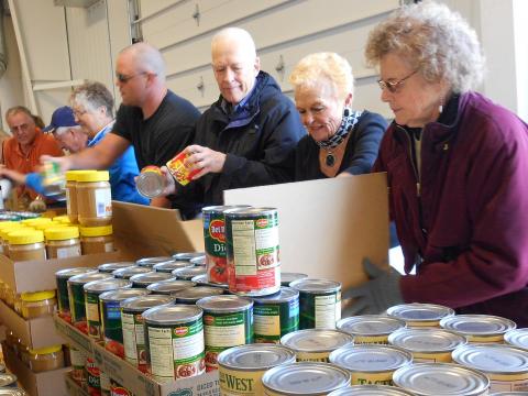 RSVP volunteers box food for low-income families